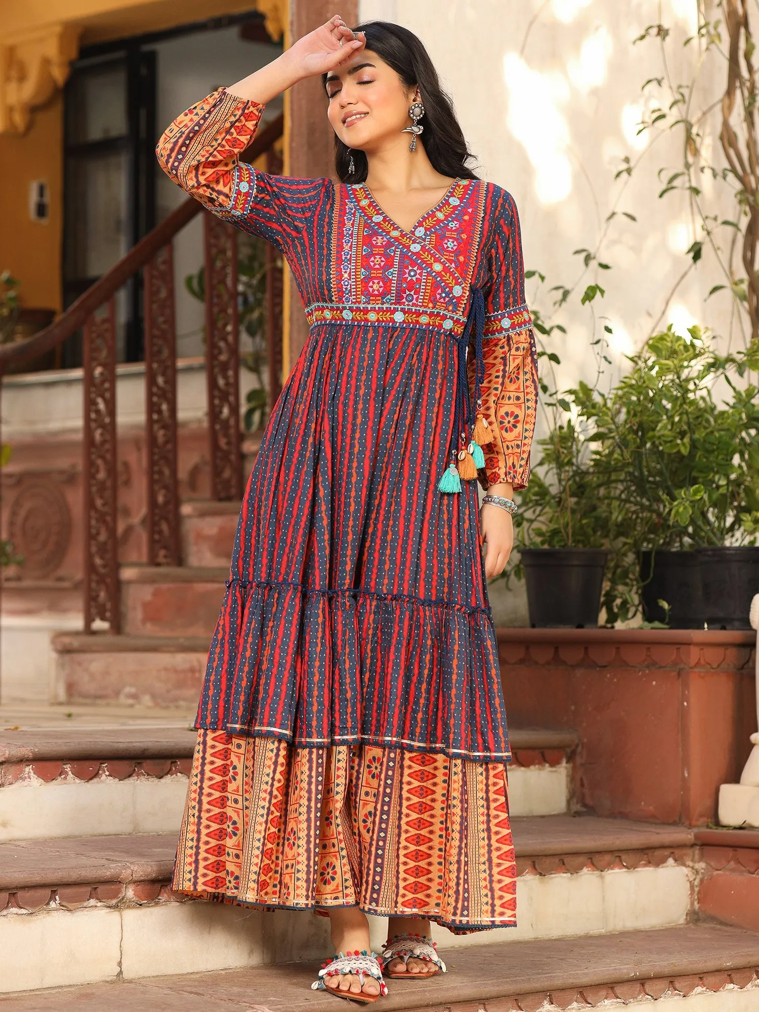 Jashvi Rust Ikat Cotton Printed Tiered Maxi Dress With Thread Embroidery & Dori Tassel Tie-Up At Waist