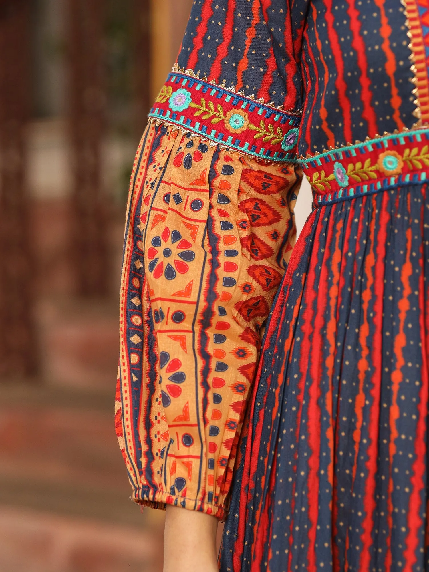 Jashvi Rust Ikat Cotton Printed Tiered Maxi Dress With Thread Embroidery & Dori Tassel Tie-Up At Waist